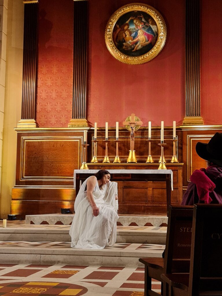 Elena Pellone sat on a chair with her white dress draped over her as she began her performance of Shakespeare's The Rape of Lucrece.