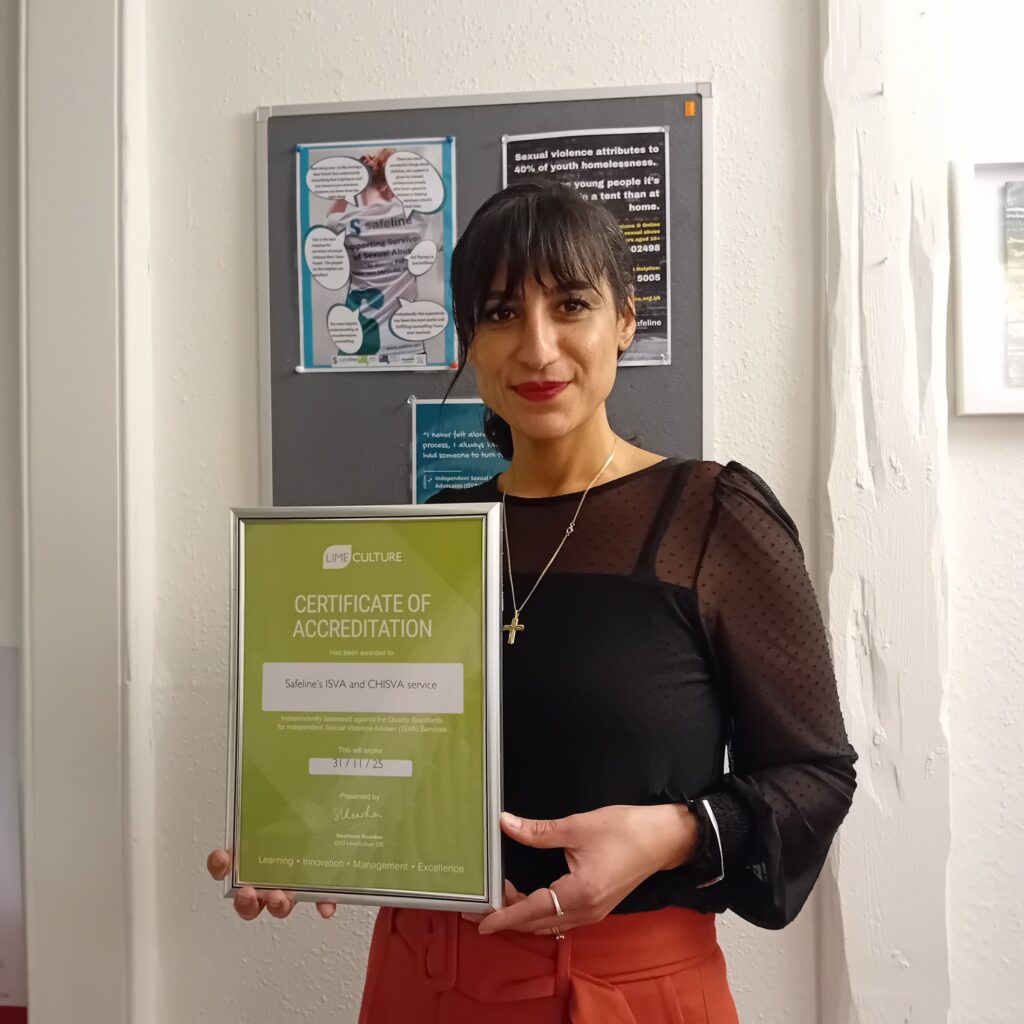 Safeline's Head of ISVA services holding a certificate of Accreditation from LimeCulture.