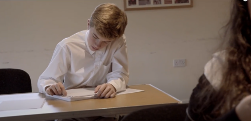 A boy writing on paper