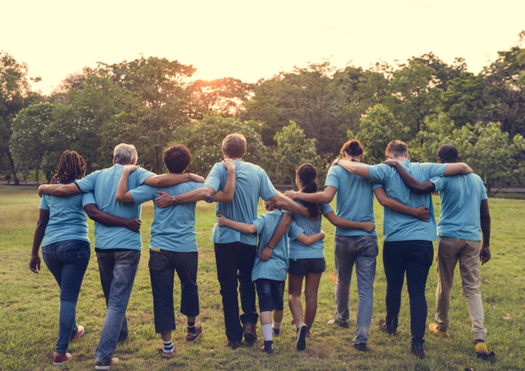 Support survivors. People in blue t shirts walking forwards