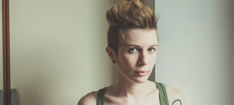 young woman with a stud on mouth. Short spiky hair