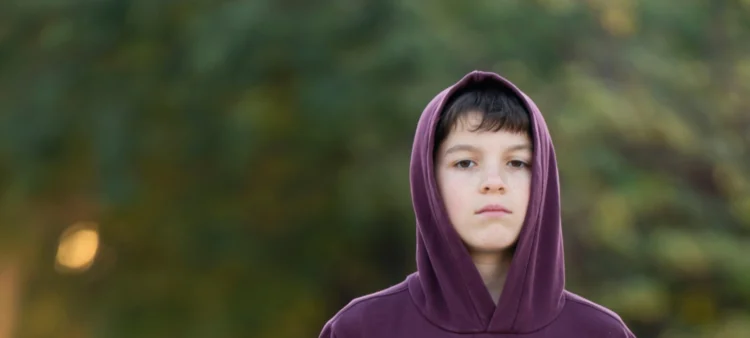 Young boy wearing a purple hoodie