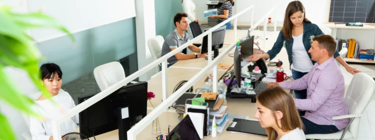 Modern bench desk seating with multiple people working on computers