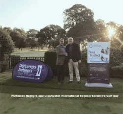 Two men on a putting green standing between corporate banners for Pertemps and Clearwater International